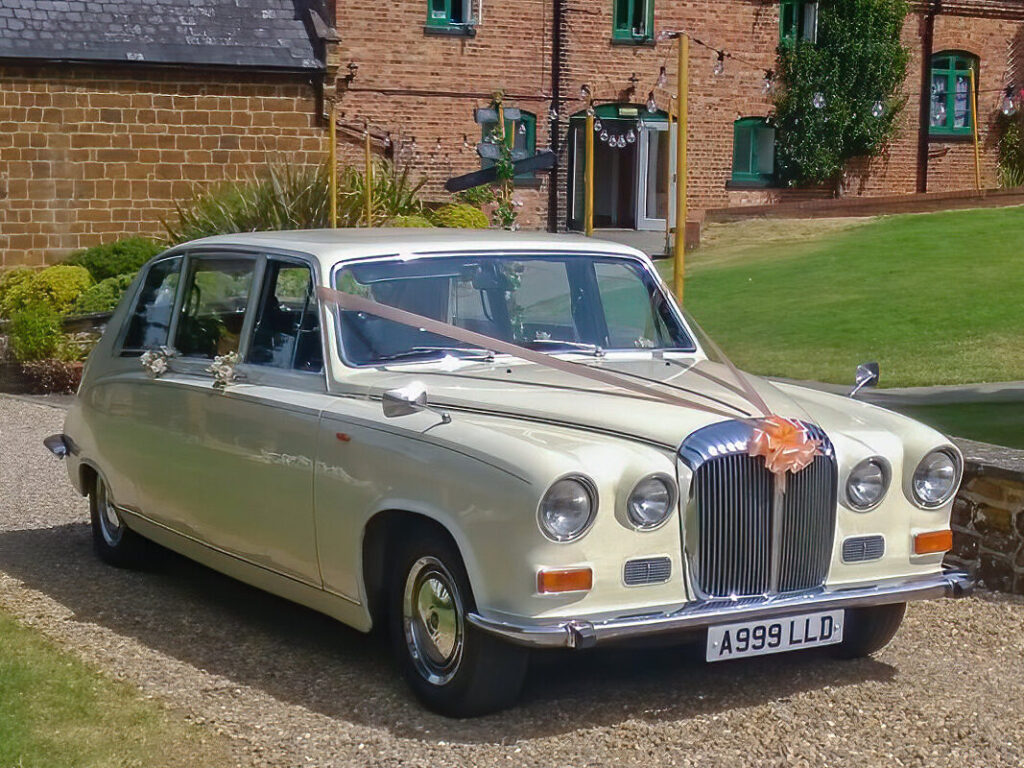 Ivory Daimler DS420 limousine decorated for a wedding